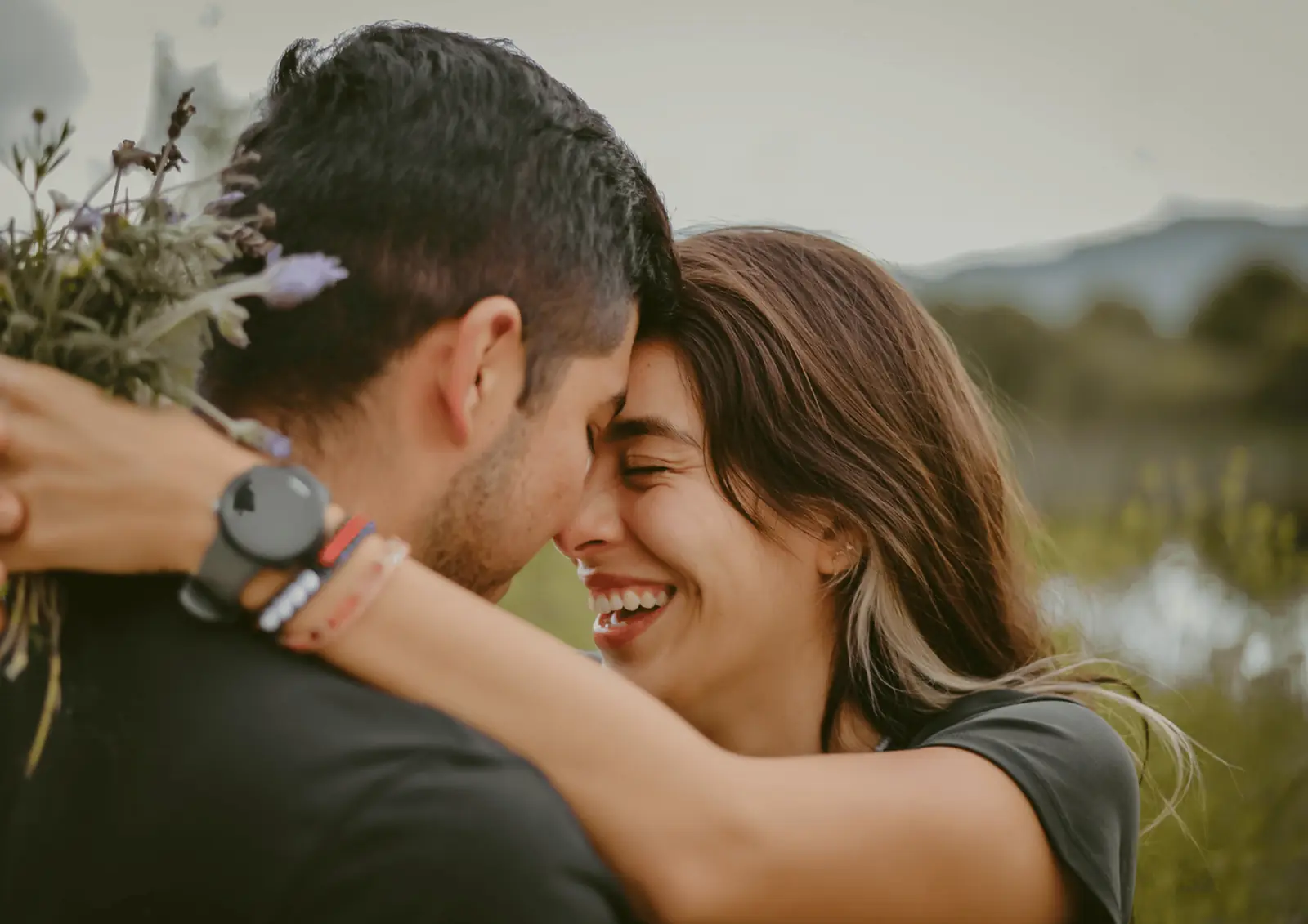 Couple touching foreheads, smiling